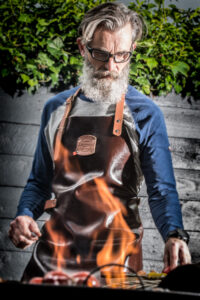 Man Grilling In A Custom Personalised Leather BBQ Apron